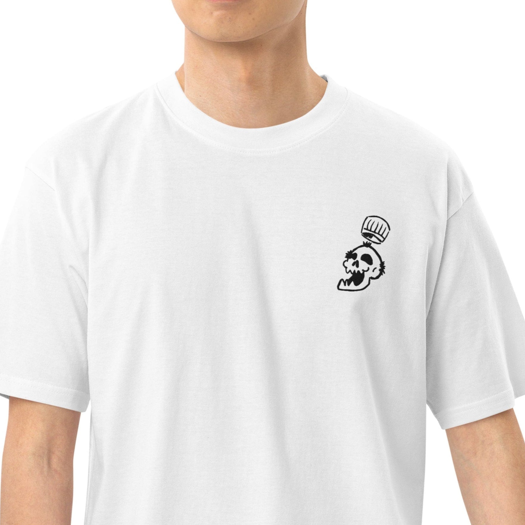 A close-up of the heavyweight fabric of the service skull Tee as worn, showing its structured drape and embroidery.